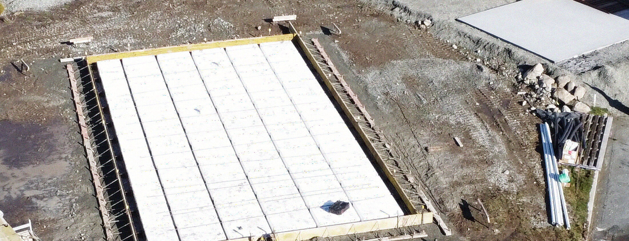 A ribraft foundation laid out ready for the pour — polystyrene pods gridded inside timber boxing.